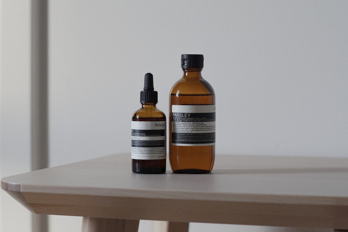 a bottle of lotion and a bottle of lotion sitting on a table