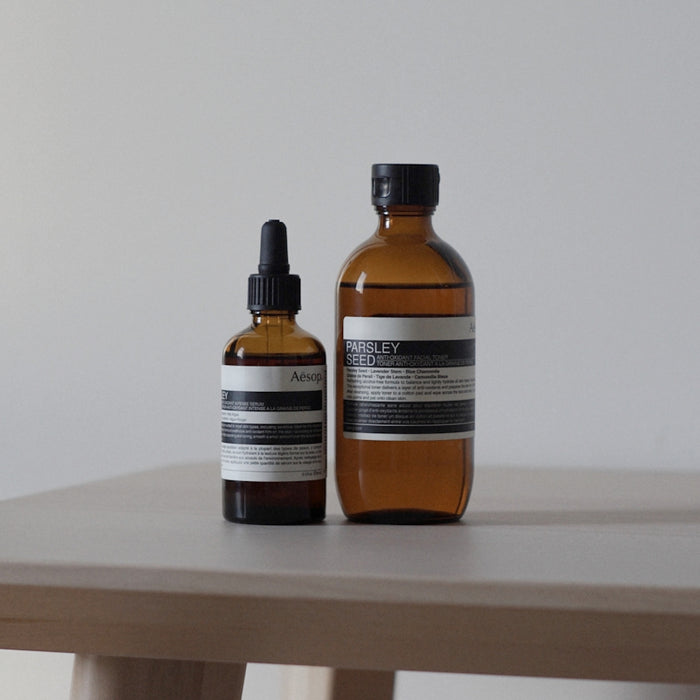 a bottle of lotion and a bottle of lotion sitting on a table